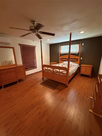 a bedroom with furniture and wooden floor