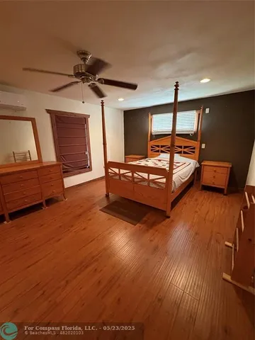 a bedroom with furniture and wooden floor