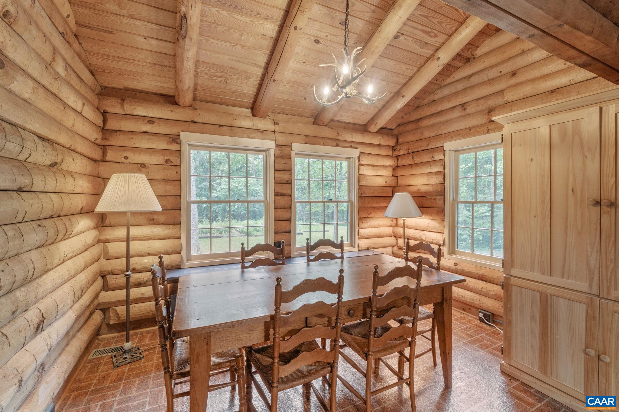165 Fitzpatrick Road Buckingham, VA 23921 - Photo 7 of 33 a dining room with furniture a chandelier and wooden floor