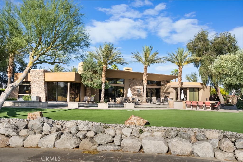 68 Royal St Georges Way Rancho Mirage, CA 92270 - Photo 12 of 75 a front view of a building with garden and trees