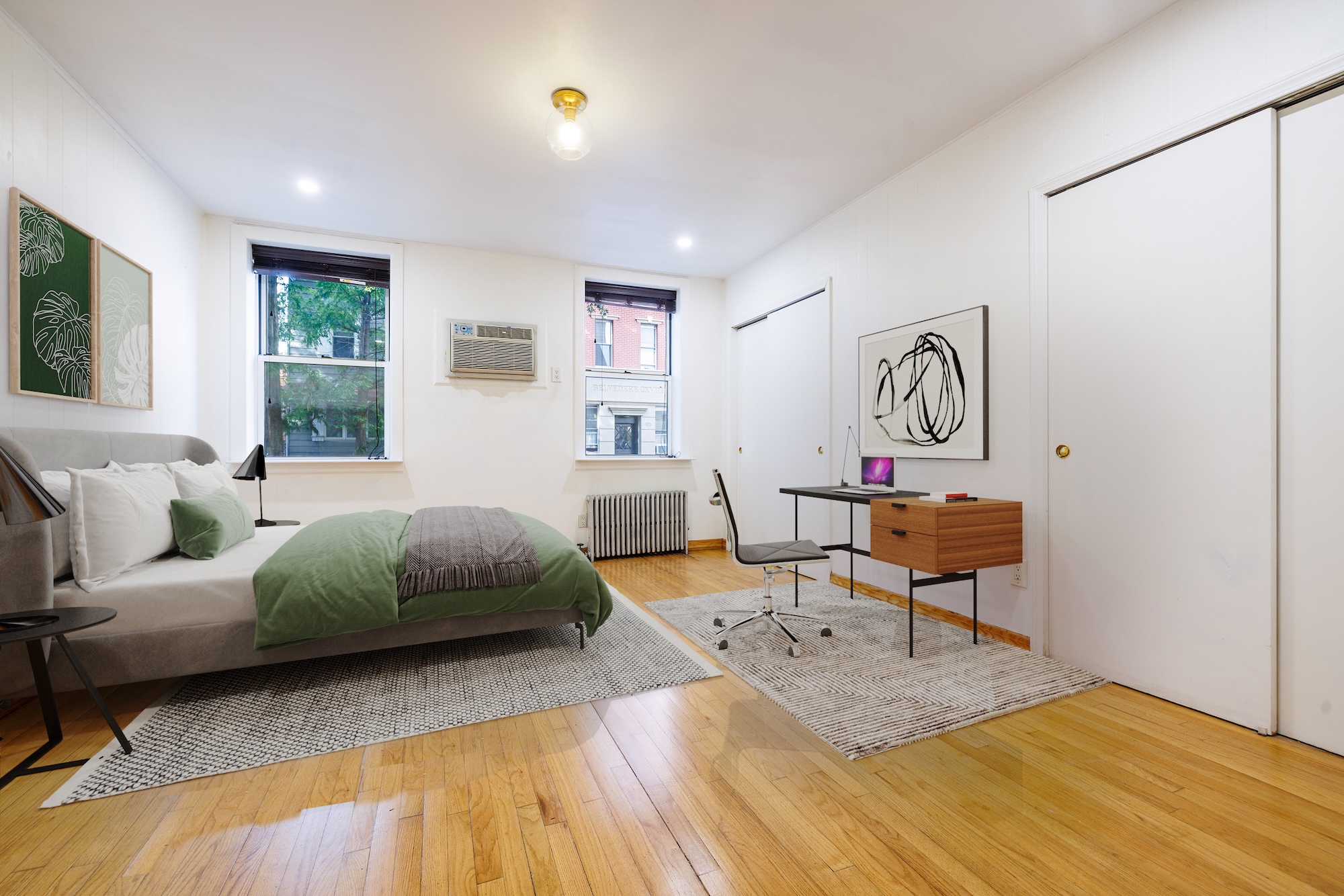 a bedroom with a bed and wooden floor