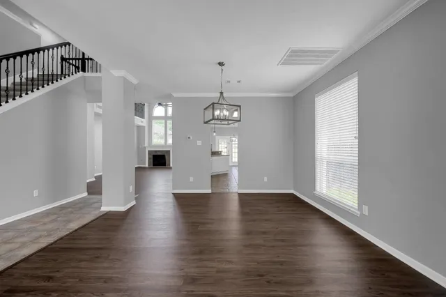 a view of a kitchen with a refrigerator and cabinets