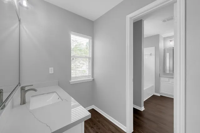 an empty room with a window and a ceiling fan