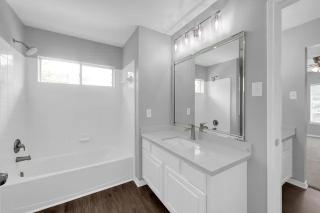 an empty room with closet and ceiling fan