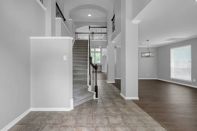a view of a room with wooden floors and stairs