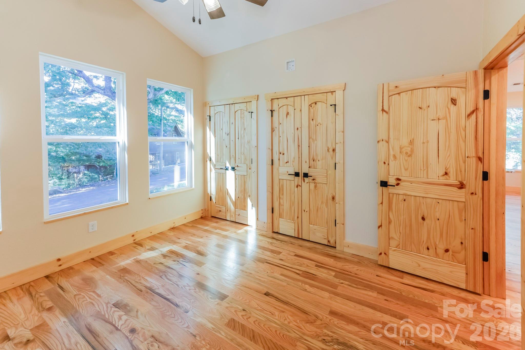 272 Seton Road Lake Lure, NC 28746 - Photo 13 of 39 a view of an empty room with wooden floor and a window