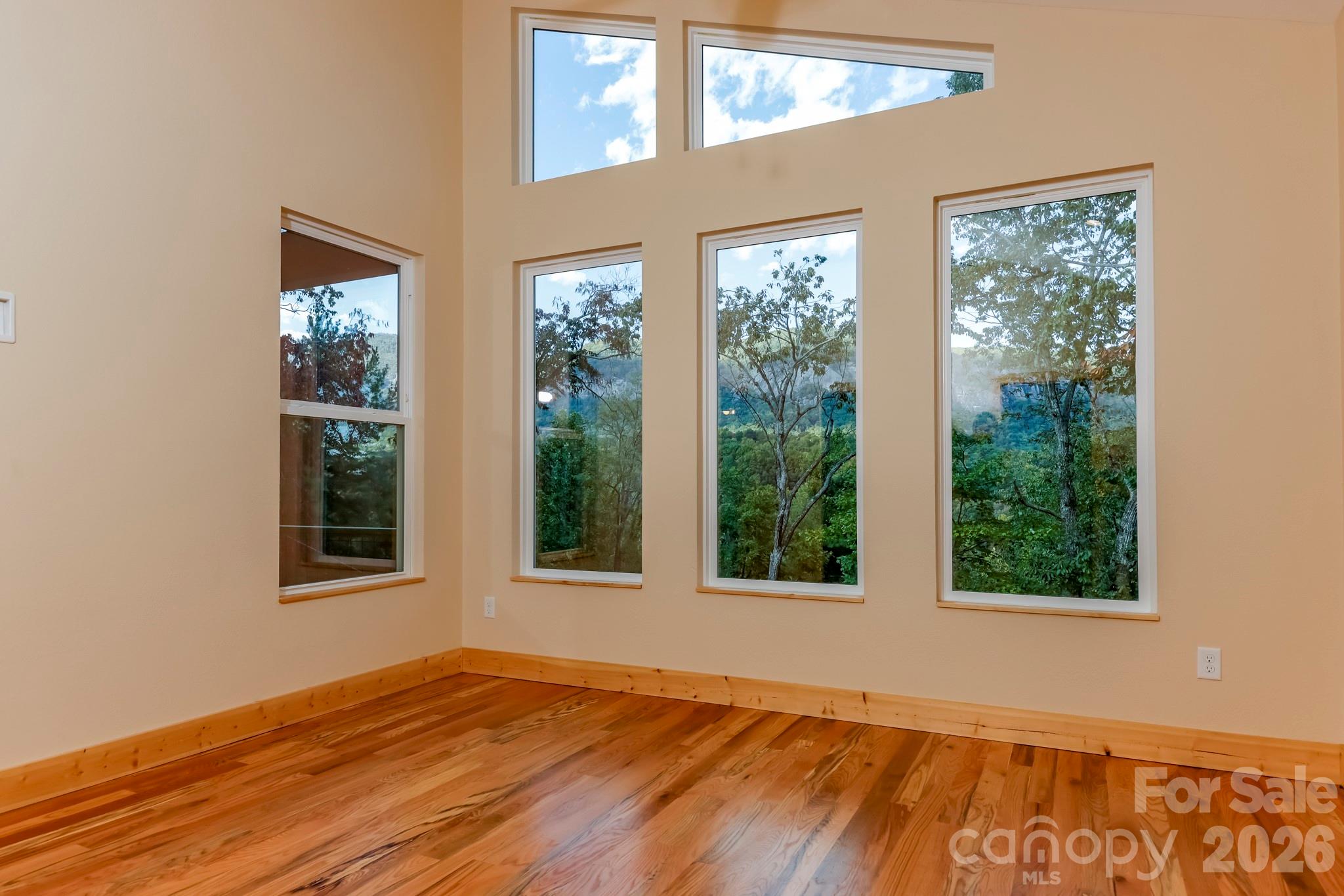 272 Seton Road Lake Lure, NC 28746 - Photo 17 of 39 a view of an empty room with wooden floor and a window