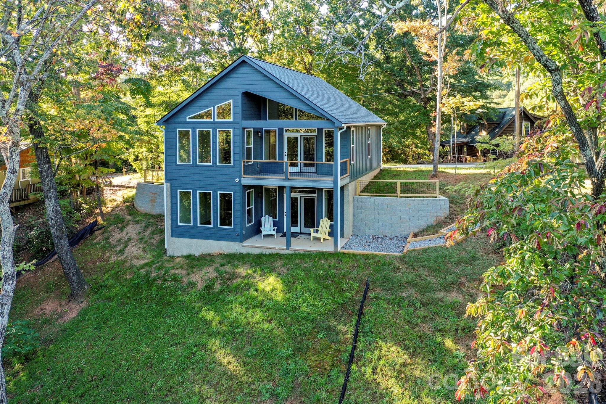 272 Seton Road Lake Lure, NC 28746 - Photo 2 of 39 a view of a house with a big yard plants and large trees