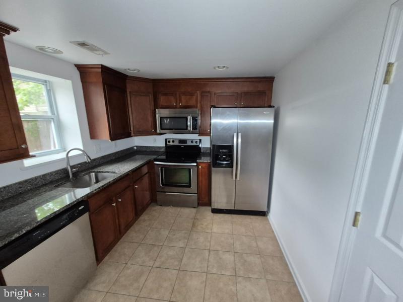 215 Sycamore Road Glen Burnie, MD 21060 - Photo 6 of 16 Modern kitchen with sleek finishes.