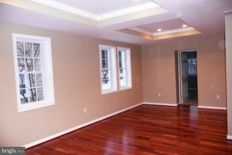 3717 Ridgecroft Road Baltimore, MD 21206 - Photo 1 of 17 a view of an empty room with wooden floor and a window