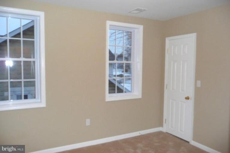 3717 Ridgecroft Road Baltimore, MD 21206 - Photo 13 of 17 a view of an empty room with a window