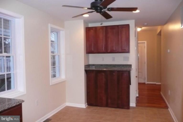 3717 Ridgecroft Road Baltimore, MD 21206 - Photo 4 of 17 a kitchen with a refrigerator and a stove