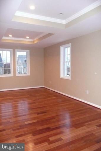 3717 Ridgecroft Road Baltimore, MD 21206 - Photo 7 of 17 a view of an empty room with wooden floor and a window