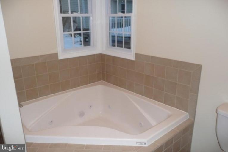 3717 Ridgecroft Road Baltimore, MD 21206 - Photo 9 of 17 a close up of a bathtub in a bathroom