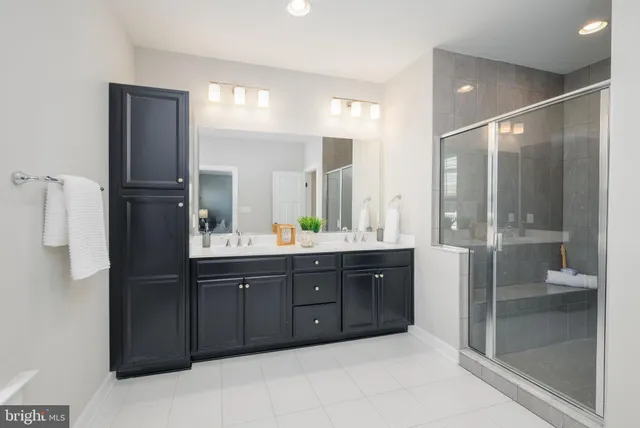 a bathroom with a tub sink shower and mirror