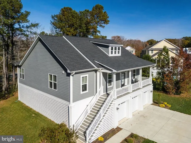 an aerial view of residential house with outdoor space and lake view