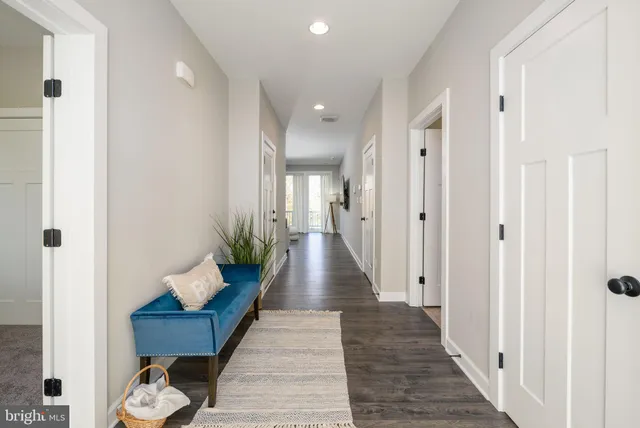 a hallway with wooden floor and furniture