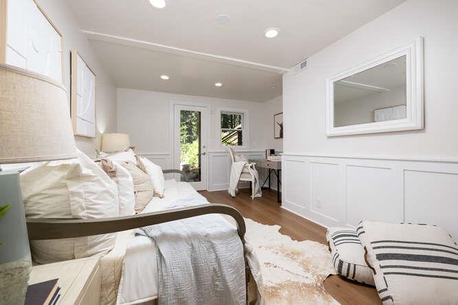 108 Ware Road Woodside, CA 94062 - Photo 34 of 56 a large bedroom with a bed and wooden floor
