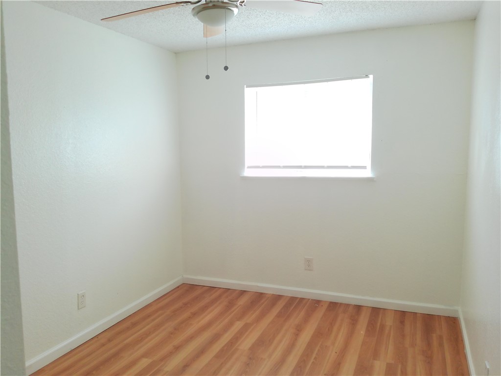 2701 Nemec Street, Unit 3 Corpus Christi, TX 78415 - Photo 8 of 11 an empty room with a window