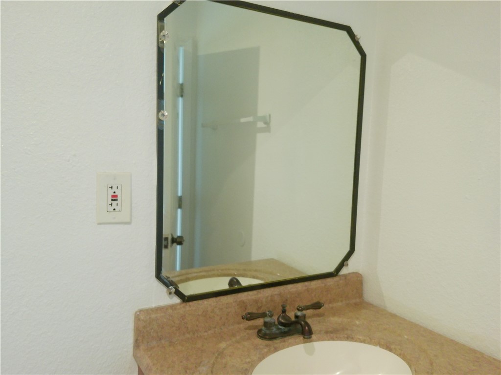 2701 Nemec Street, Unit 3 Corpus Christi, TX 78415 - Photo 9 of 11 a bathroom with a sink and a mirror