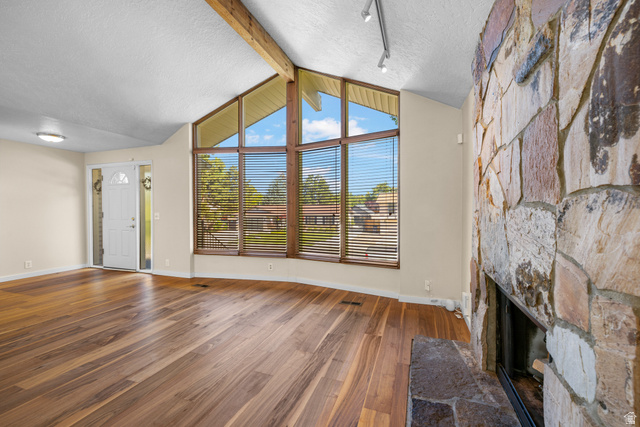 2088 Falcon Way Sandy, UT 84093 - Photo 8 of 46 Wood-finish flooring throughout, complemented by a prominent stone fireplace