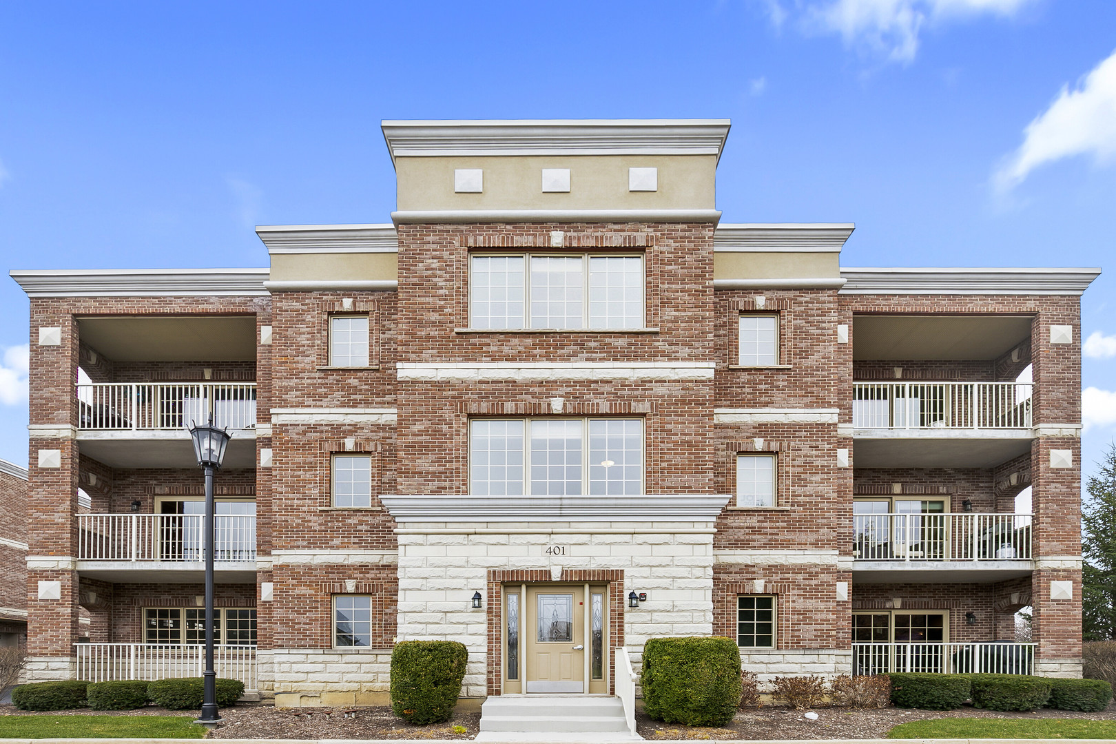 401 West Pierce Road, Unit 201 Itasca, IL 60143 - Photo 1 of 24 a front view of a building with many windows