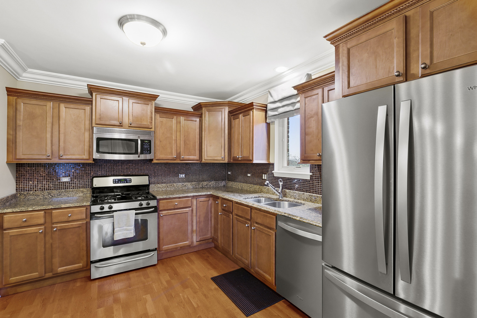 401 West Pierce Road, Unit 201 Itasca, IL 60143 - Photo 6 of 24 a kitchen with stainless steel appliances granite countertop a refrigerator stove microwave and sink