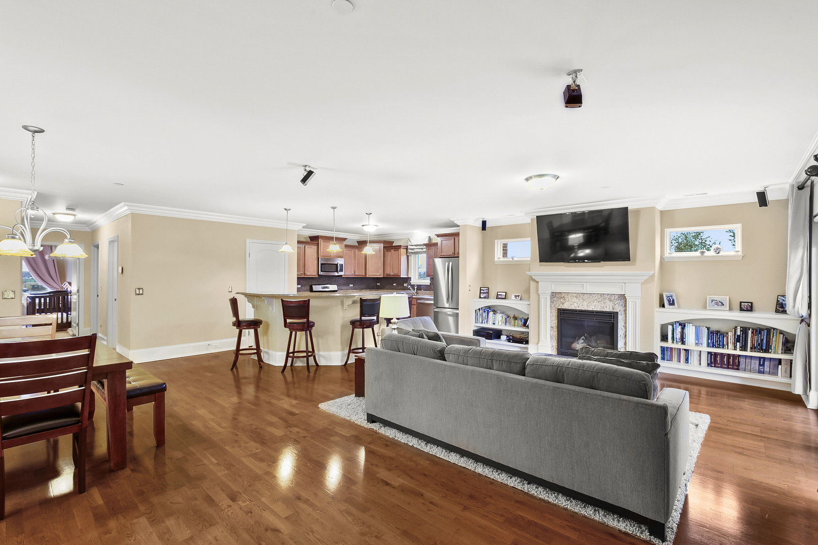 401 West Pierce Road, Unit 201 Itasca, IL 60143 - Photo 10 of 24 a living room with furniture a fireplace and a flat screen tv