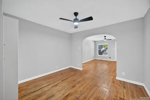 a view of empty room with wooden floor