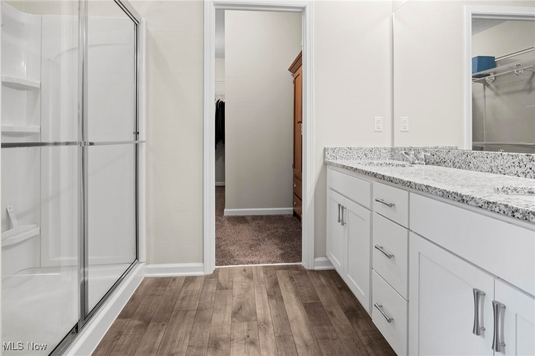 6824 Hatching Way North Ridgeville, OH 44039 - Photo 20 of 42 Bathroom with a shower with door, vanity, and hardwood / wood-style floors