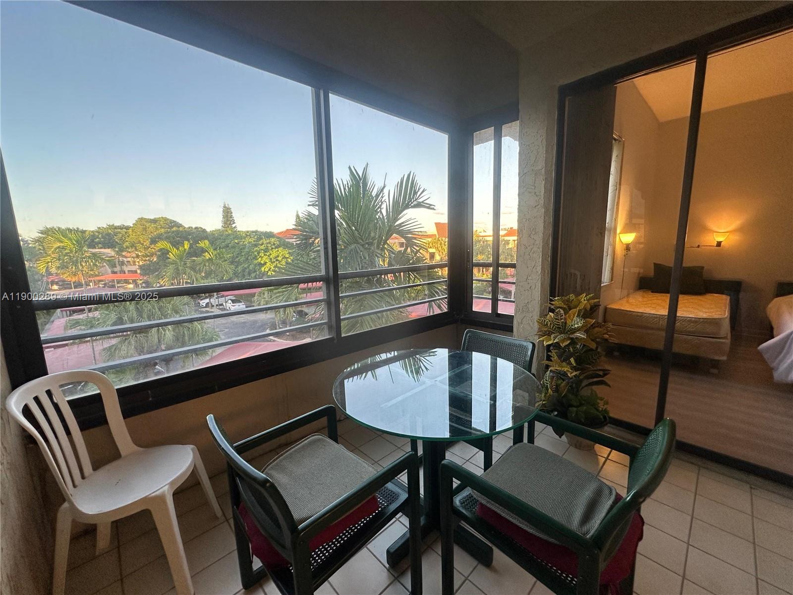 7472 La Paz Boulevard, Unit 301 Boca Raton, FL 33433 - Photo 14 of 17 a living room with furniture and a floor to ceiling window