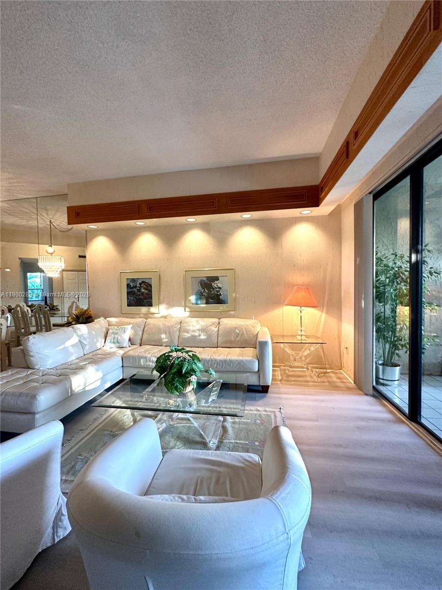 7472 La Paz Boulevard, Unit 301 Boca Raton, FL 33433 - Photo 7 of 17 a living room with furniture and a floor to ceiling window