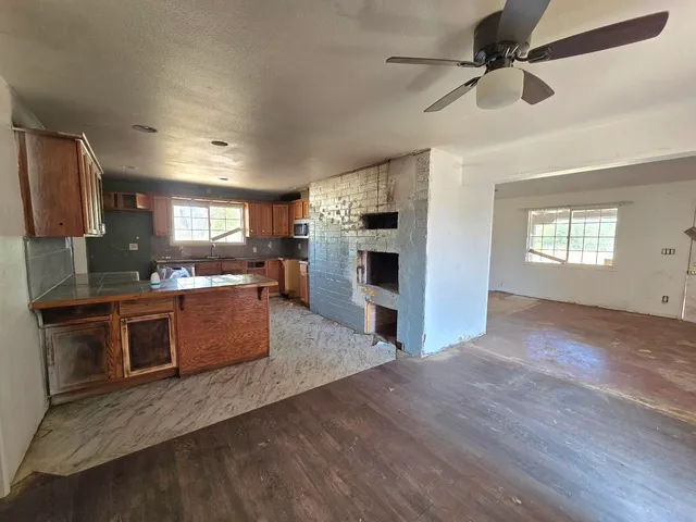 a large kitchen with stainless steel appliances granite countertop a stove refrigerator and a sink