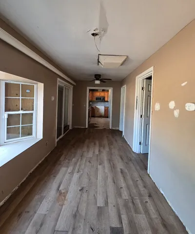 wooden floor in an empty room with a window