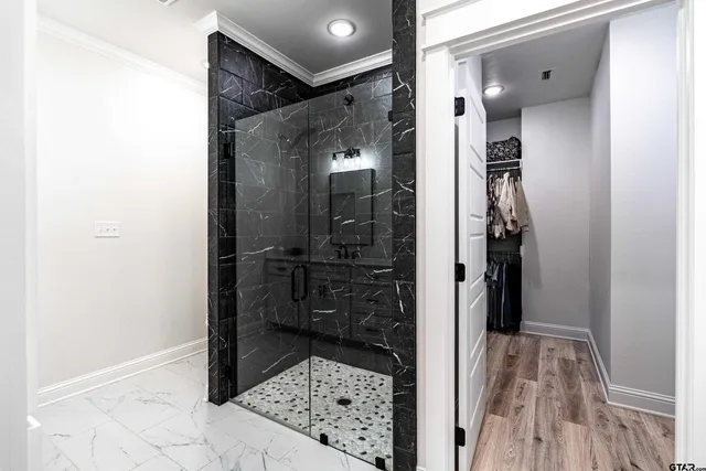 a bathroom with a glass shower door