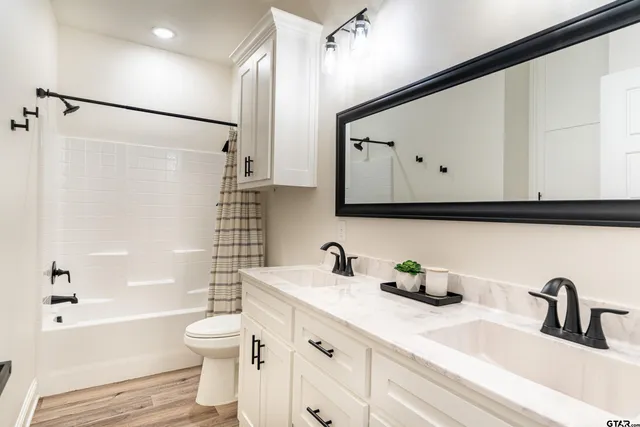 a bathroom with a sink a toilet and a bathtub