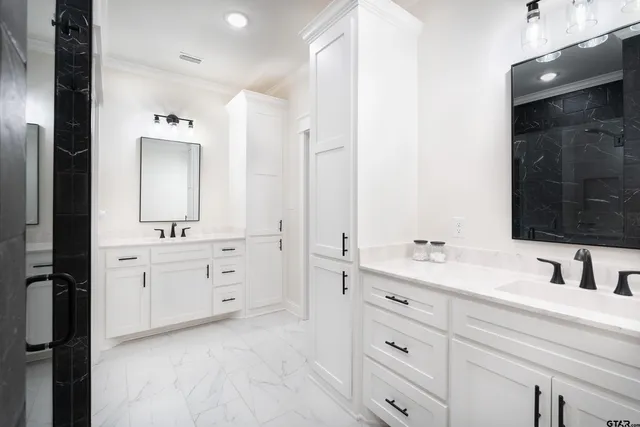a bathroom with a double vanity sink a mirror and a bathtub