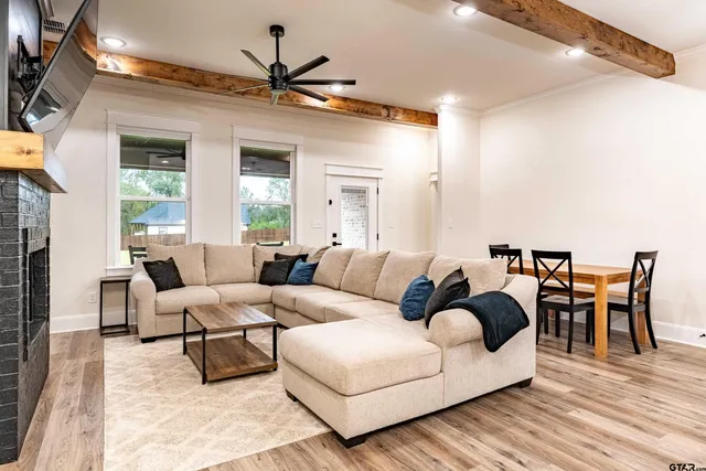a living room with furniture and a wooden floor
