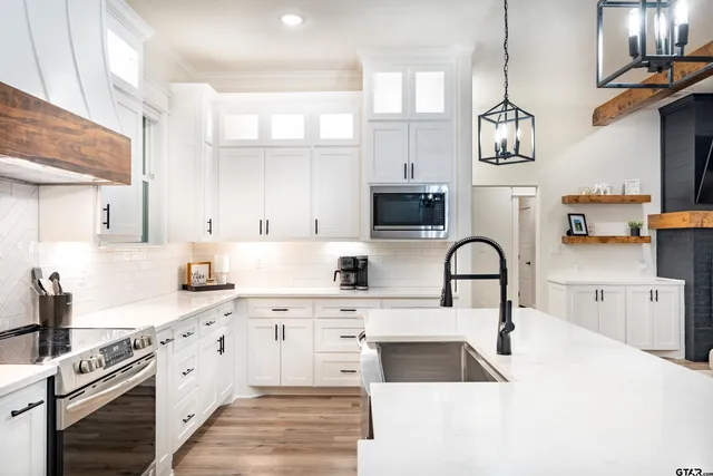 a kitchen with a sink cabinets and window