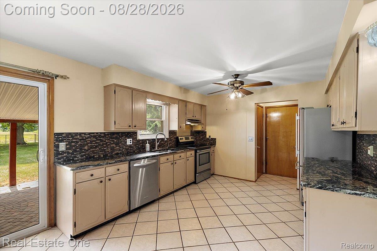 15250 34 Mile Road Armada, MI 48005 - Photo 25 of 49 White tile flooring, mosaic tile backsplash, stainless steel appliances, sliding glass patio door, and recessed lighting