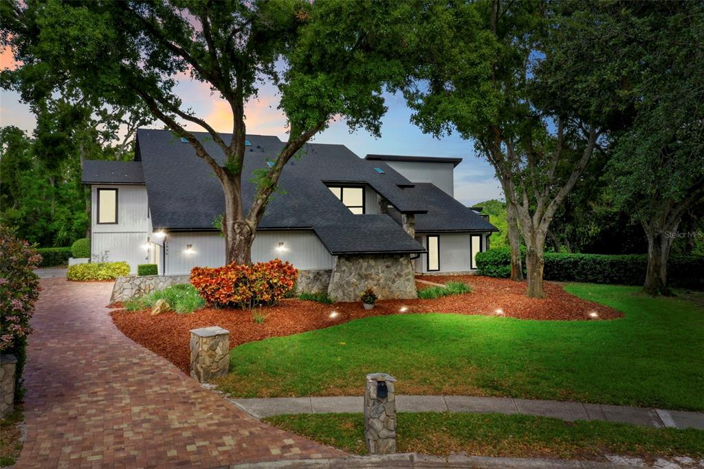 2936 Eagle Estates Circle North Clearwater, FL 33761 - Photo 1 of 1 a front view of a house with a garden and trees
