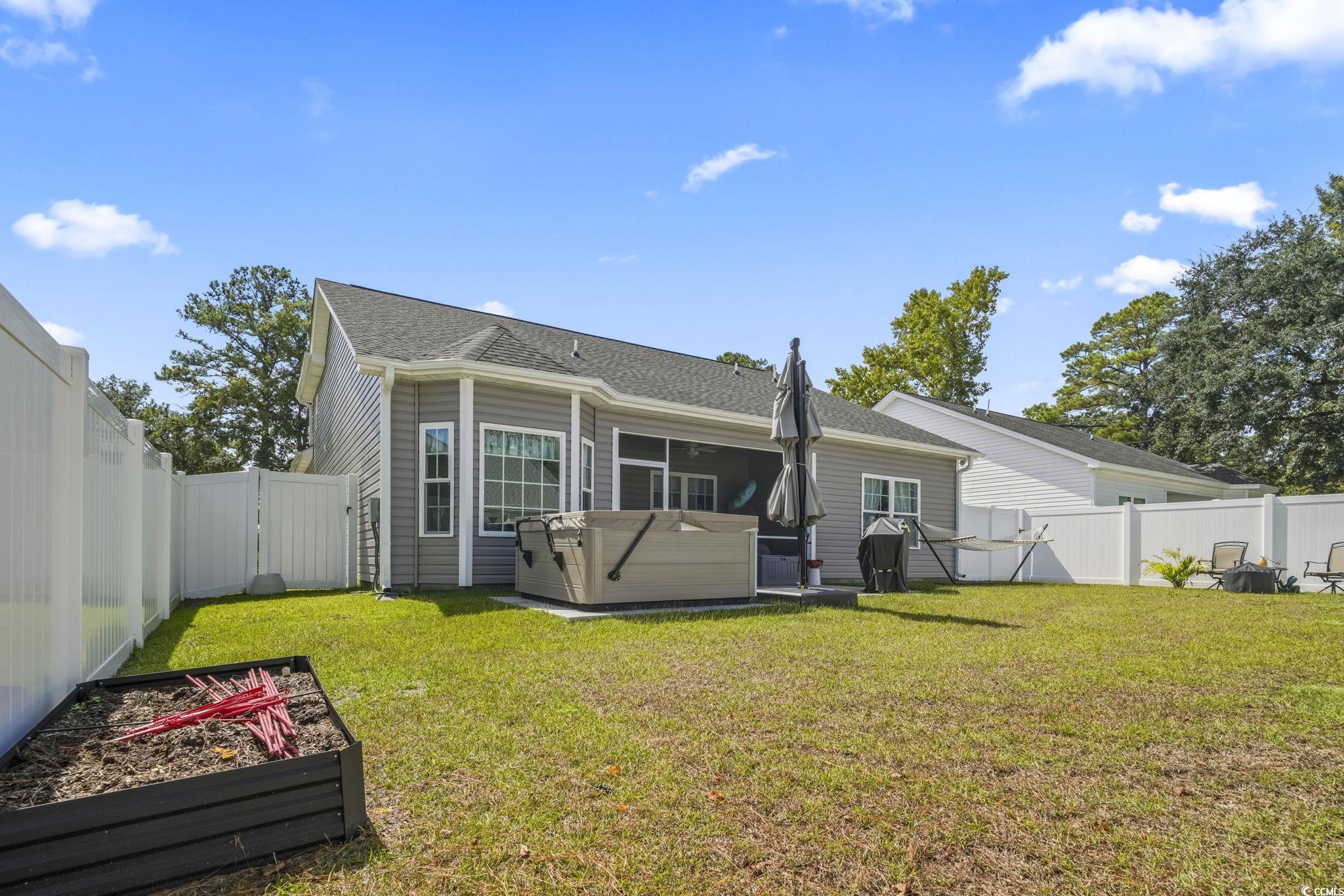 308 Concorde Drive Georgetown, SC 29440 - Photo 34 of 40 Rear view of house with a fenced backyard and patio