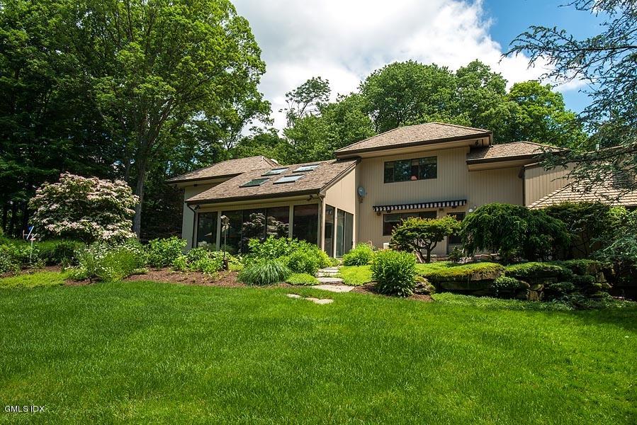 163 Clapboard Ridge Road Greenwich, CT 06831 - Photo 14 of 17 a front view of a house with a yard and potted plants