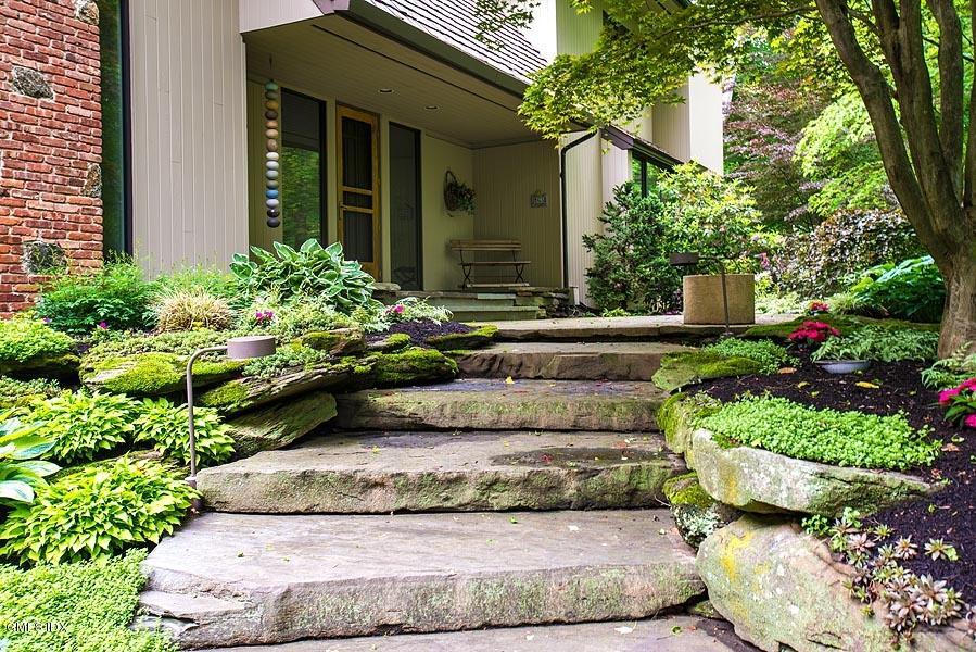 163 Clapboard Ridge Road Greenwich, CT 06831 - Photo 2 of 17 a view of a house with a yard and plants