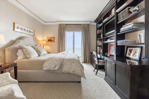 a bedroom with a bed couch and a window