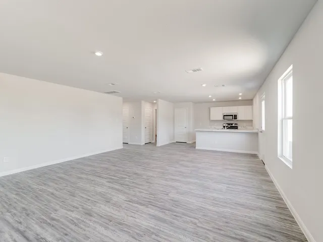 a view of a kitchen with wooden floor and a sink