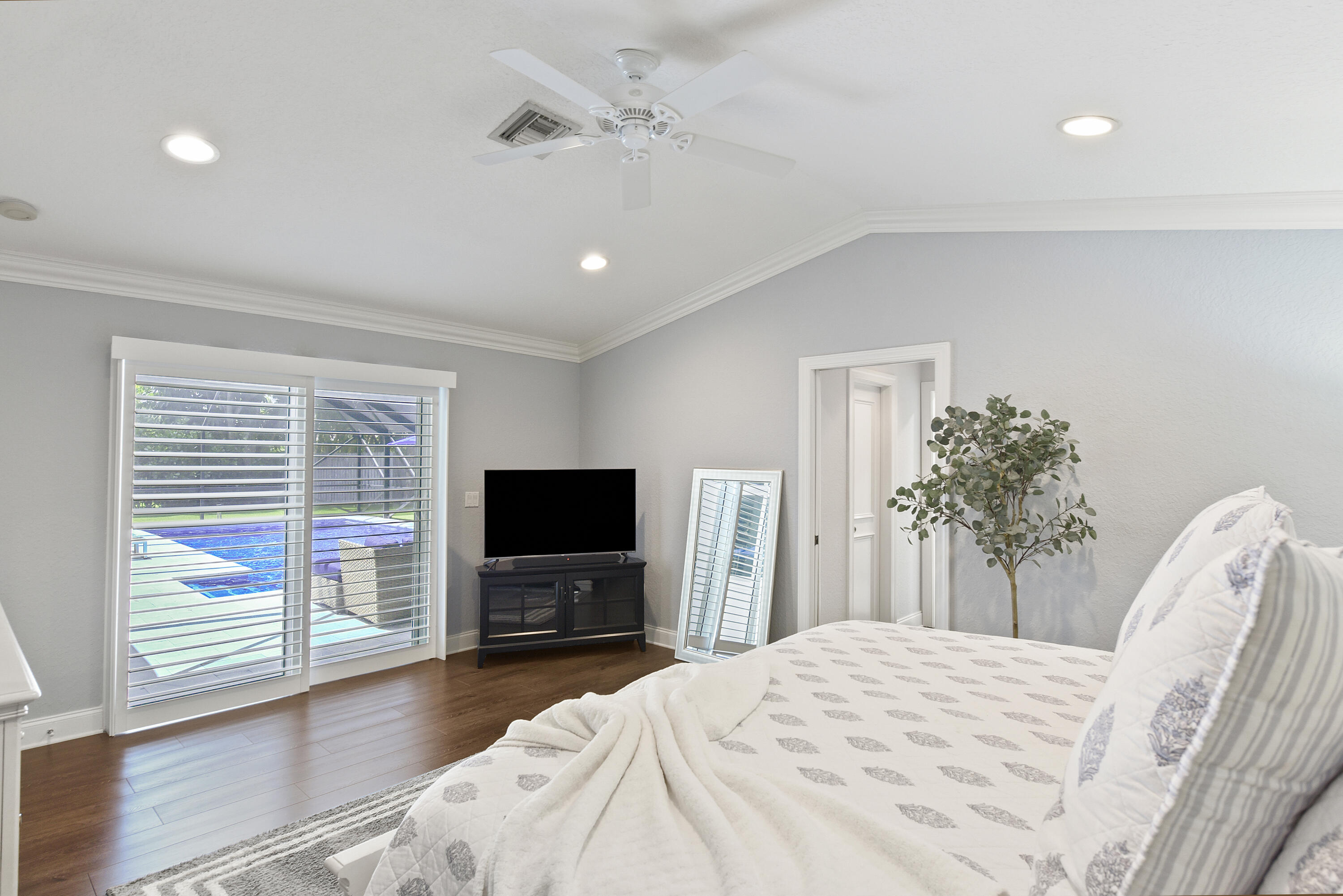 2659 Northwest 26th Circle Boca Raton, FL 33431 - Photo 15 of 34 a bedroom with a bed and a flat screen tv