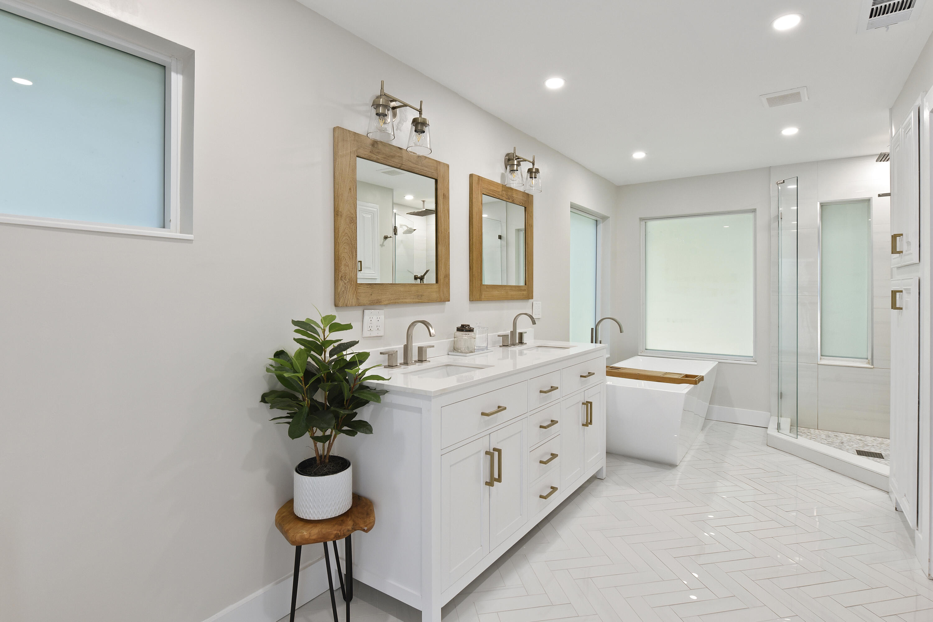 2659 Northwest 26th Circle Boca Raton, FL 33431 - Photo 17 of 34 a bathroom with a double vanity sink mirror and a bathtub
