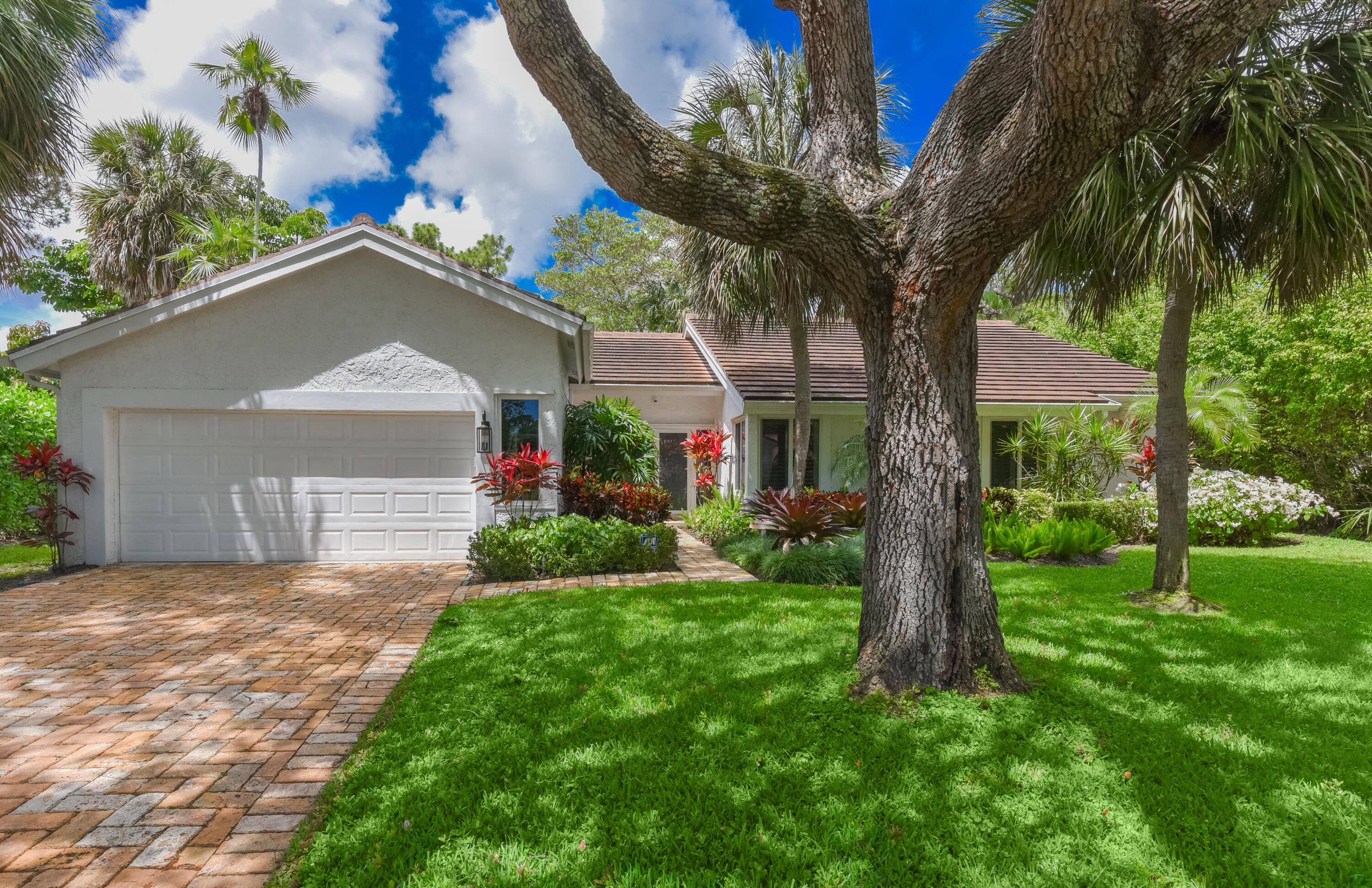 2659 Northwest 26th Circle Boca Raton, FL 33431 - Photo 2 of 34 a front view of a house with a yard and garage