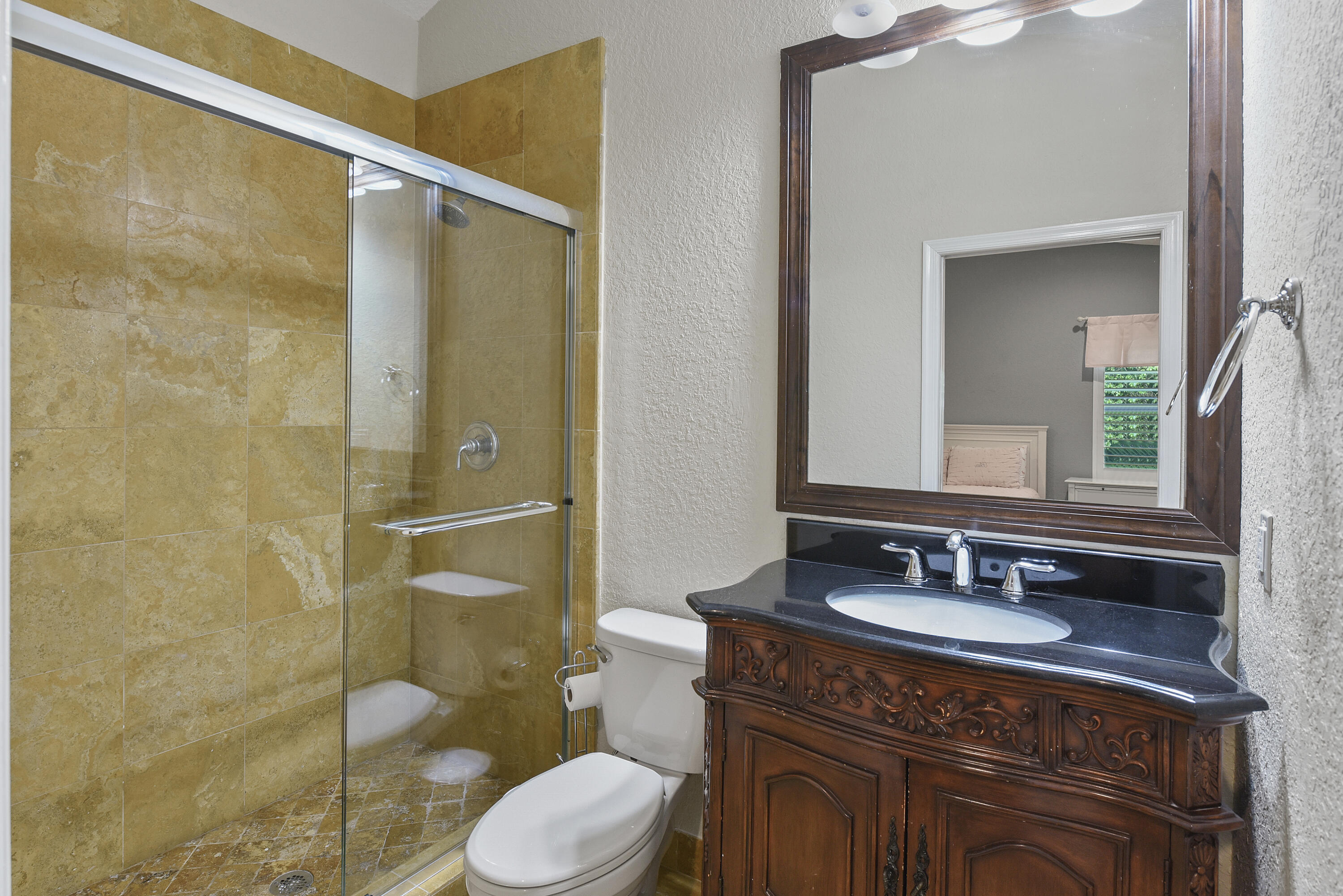 2659 Northwest 26th Circle Boca Raton, FL 33431 - Photo 22 of 34 a bathroom with a granite countertop sink toilet and shower
